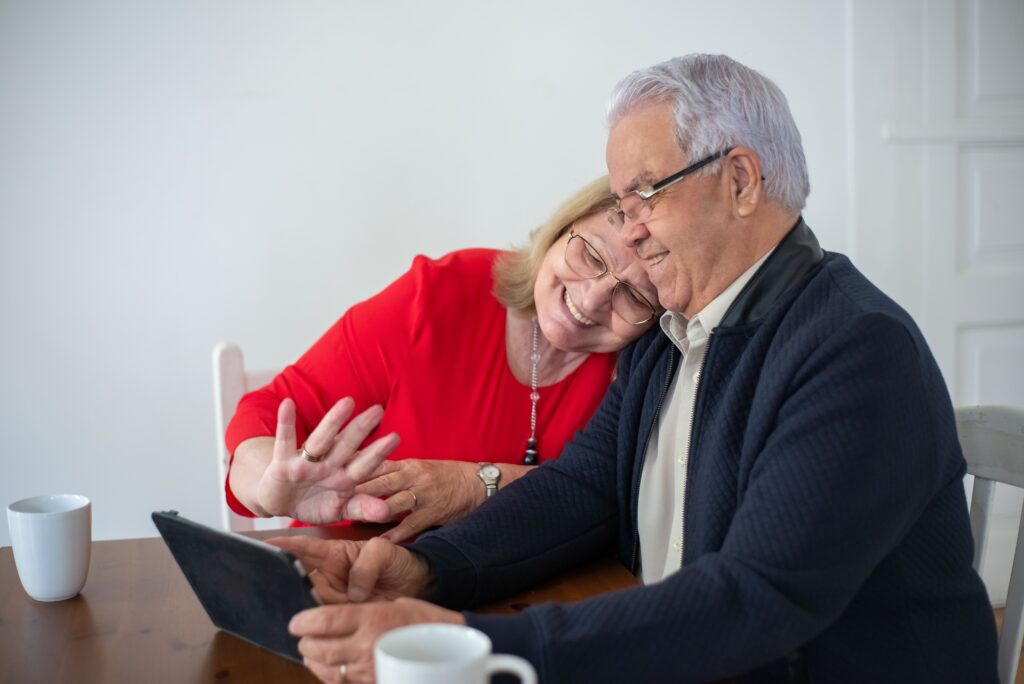 Grandmother and Grandfather waving at screen