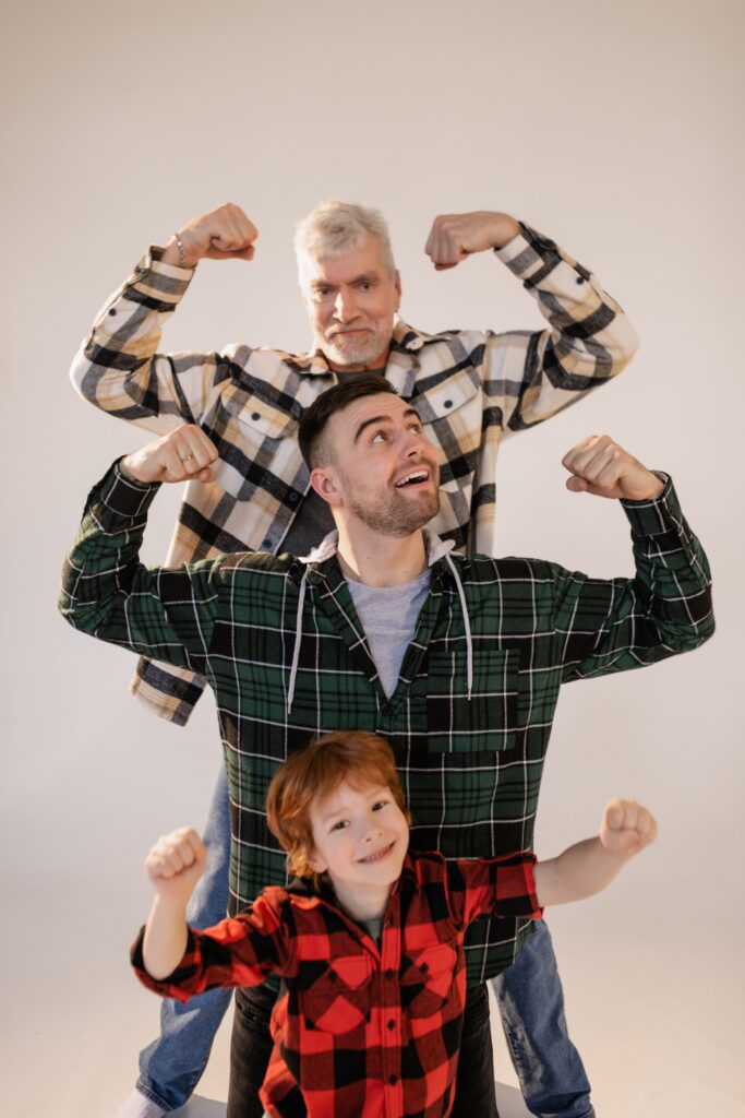 Grandparent, adult child, and grandchild relaxing together in the family home